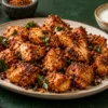 Air-fried chicken breast pieces coated in Karnataka podi, served with lemon and curd dip