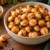 Crisp roasted makhana coated lightly with podi in a ceramic bowl