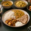 North Indian meal with dal, rice, paratha, curd, sabzi and podi