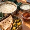 Office lunch tiffin with rice, roti, curd and podi packed in a separate small container