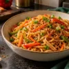 Vegetable noodles with podi seasoning in a ceramic bowl