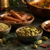 Fennel seeds, cinnamon, green cardamom and browned onions beside a curry
