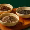 Illustrative bowls of whole cumin, caraway and dark shahi jeera-style spice seeds.
