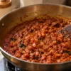 Cooked onion-tomato masala with oil visible near the edges