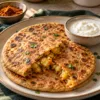 Golden aloo paratha opened to show podi-seasoned potato filling