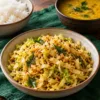 Podi cabbage stir-fry served beside bowls of dal and rice
