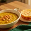 Thick chana dal with a light podi finish served beside crisp flat pakwan.