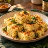 Steamed rava dhokla squares with a light podi sprinkle