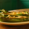 Green capsicum halves filled with potato, peas and podi seasoning.